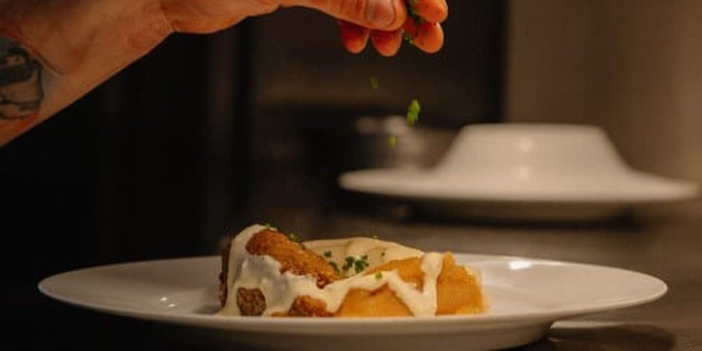 A dish being finished at Howies, Edinburgh